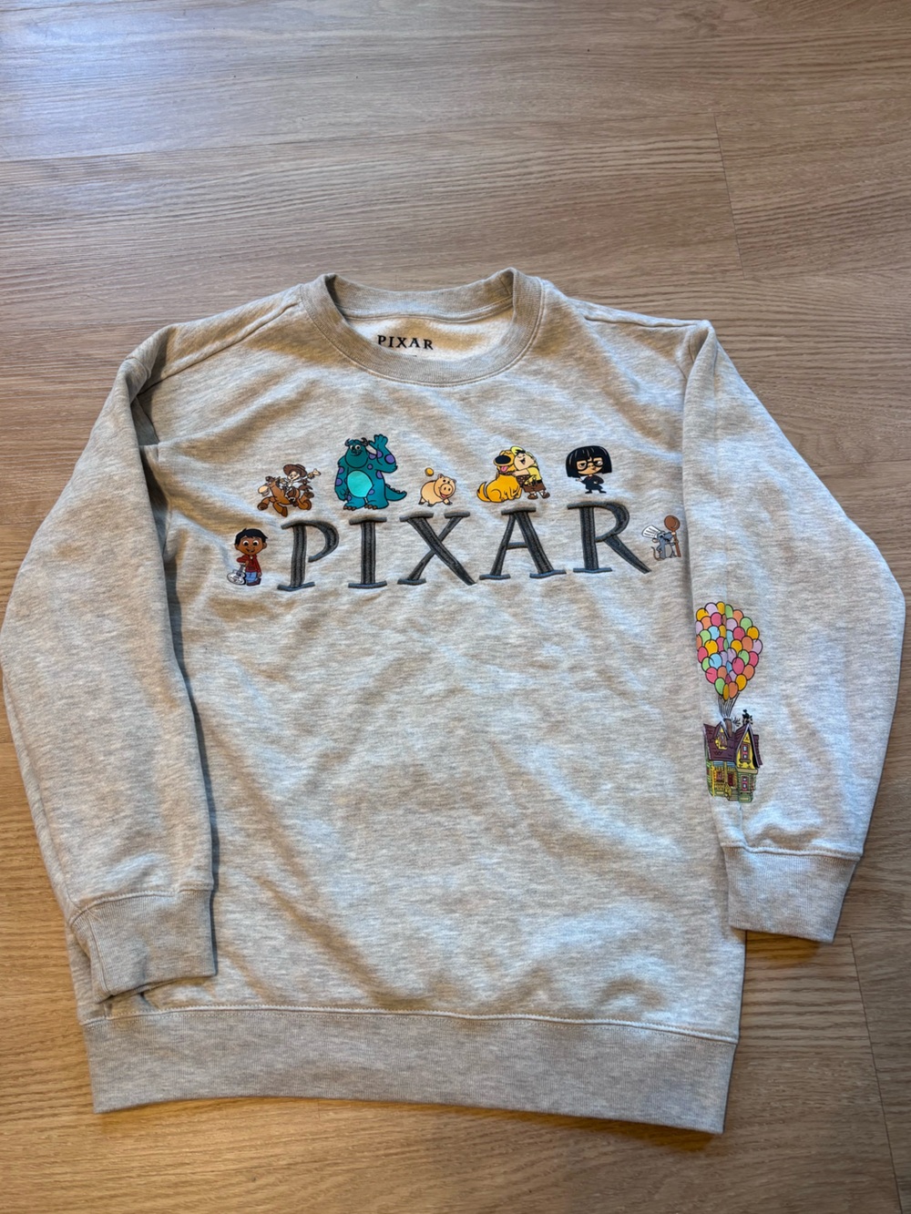 PIXAR Juniors S (Fits Women’s XS) Cotton Blend Graphic Crewneck Disney